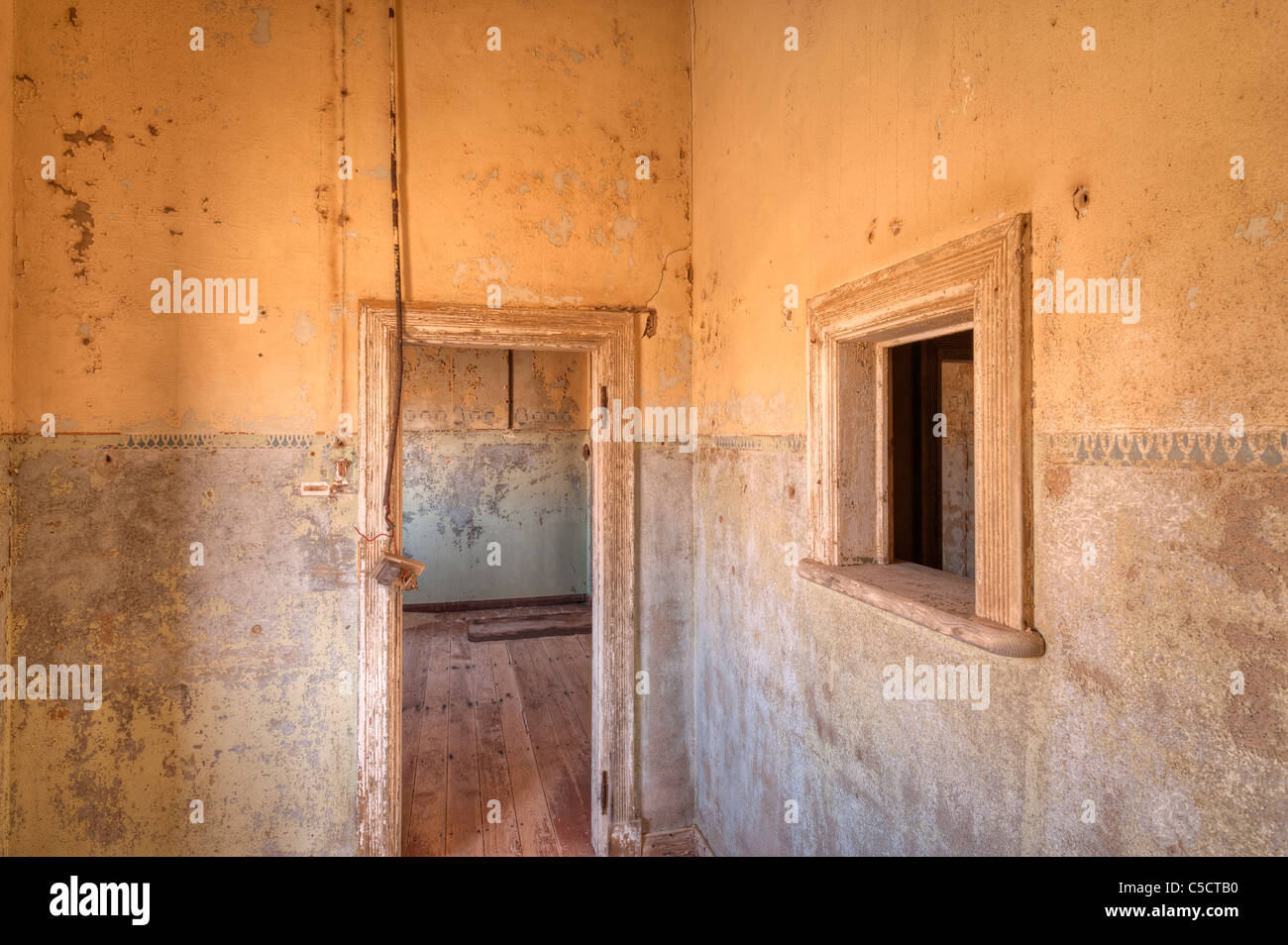 Empty kitchen and doorway in abandoned building, Kolmanskop Ghost Town near Luderitz, Namibia, Africa Stock Photo