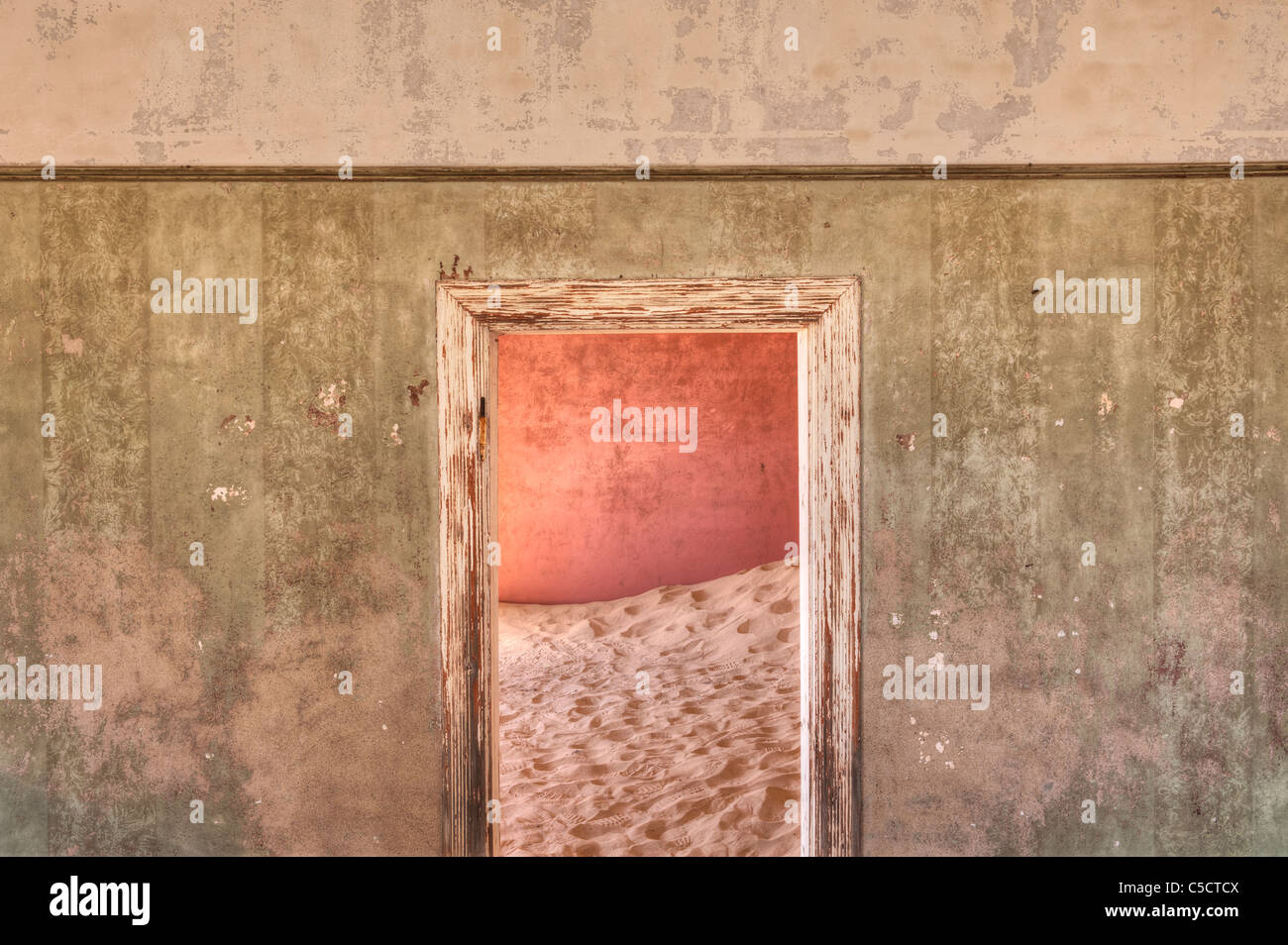Interleading door in sand-filled building, Kolmanskop Ghost Town near Luderitz, Namibia, Africa. Stock Photo