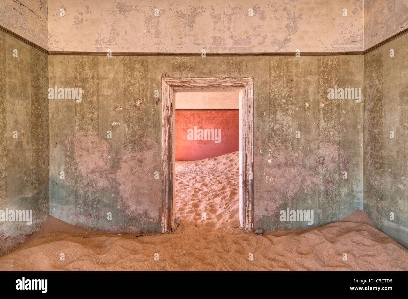 Interleading door in sand-filled building, Kolmanskop Ghost Town near Luderitz, Namibia, Africa Stock Photo