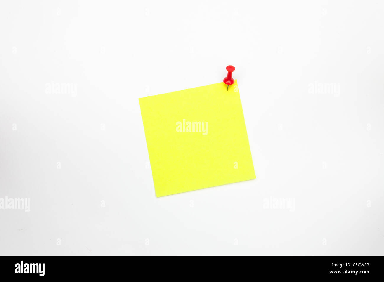a yellow notepad with a red pin needle Stock Photo