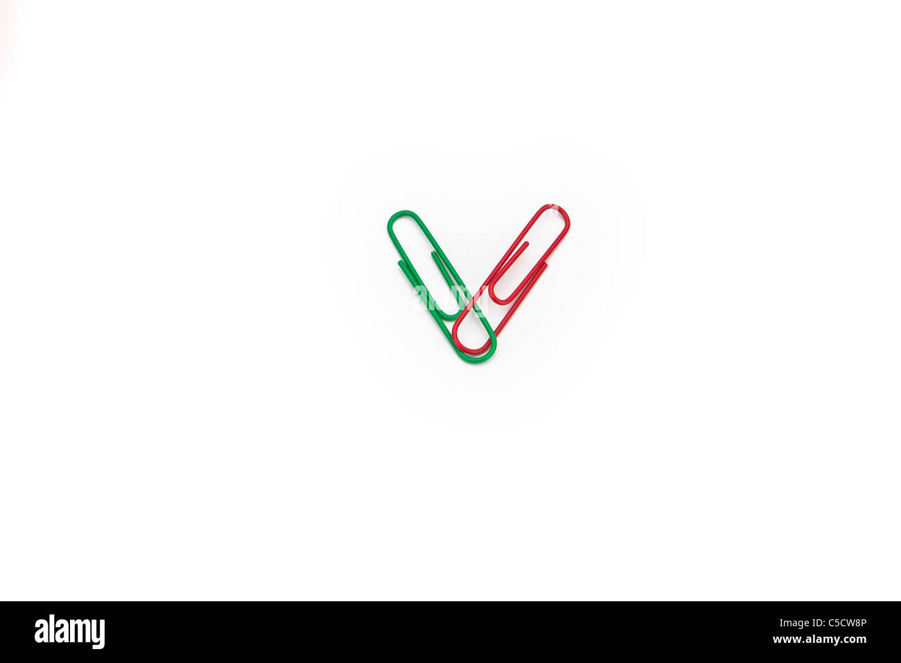 two paper clips in the colors green and red on white background Stock Photo