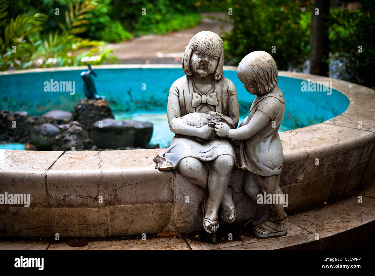 An Empty Fountain With A Broken Statue Of Girls Holding A Rabbit At Stock Photo Alamy