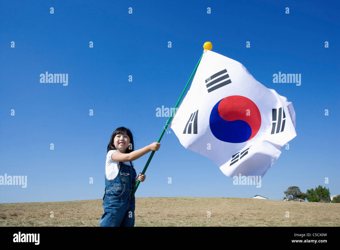 Korean National Flag blowing in girl's hand Stock Photo