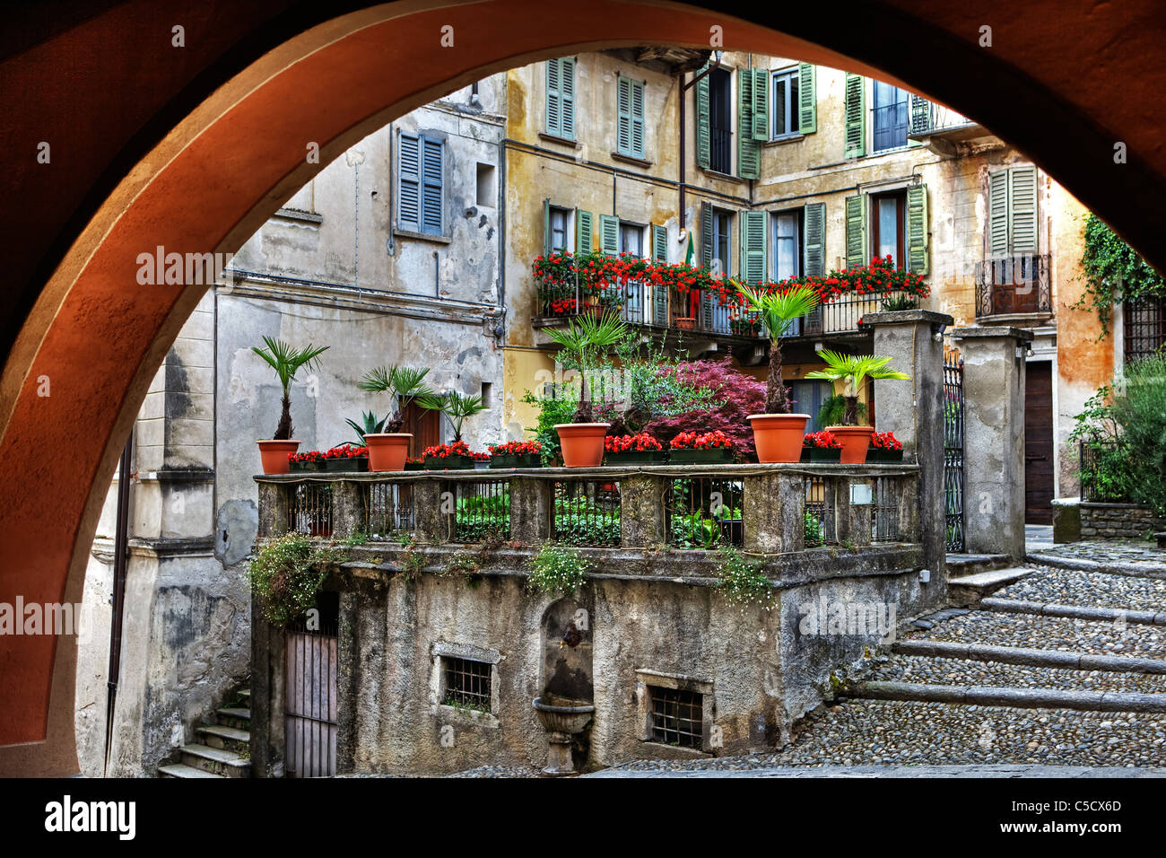 Looking through an arch in old houses in the town of Orta in Piedmont, Italy Stock Photo