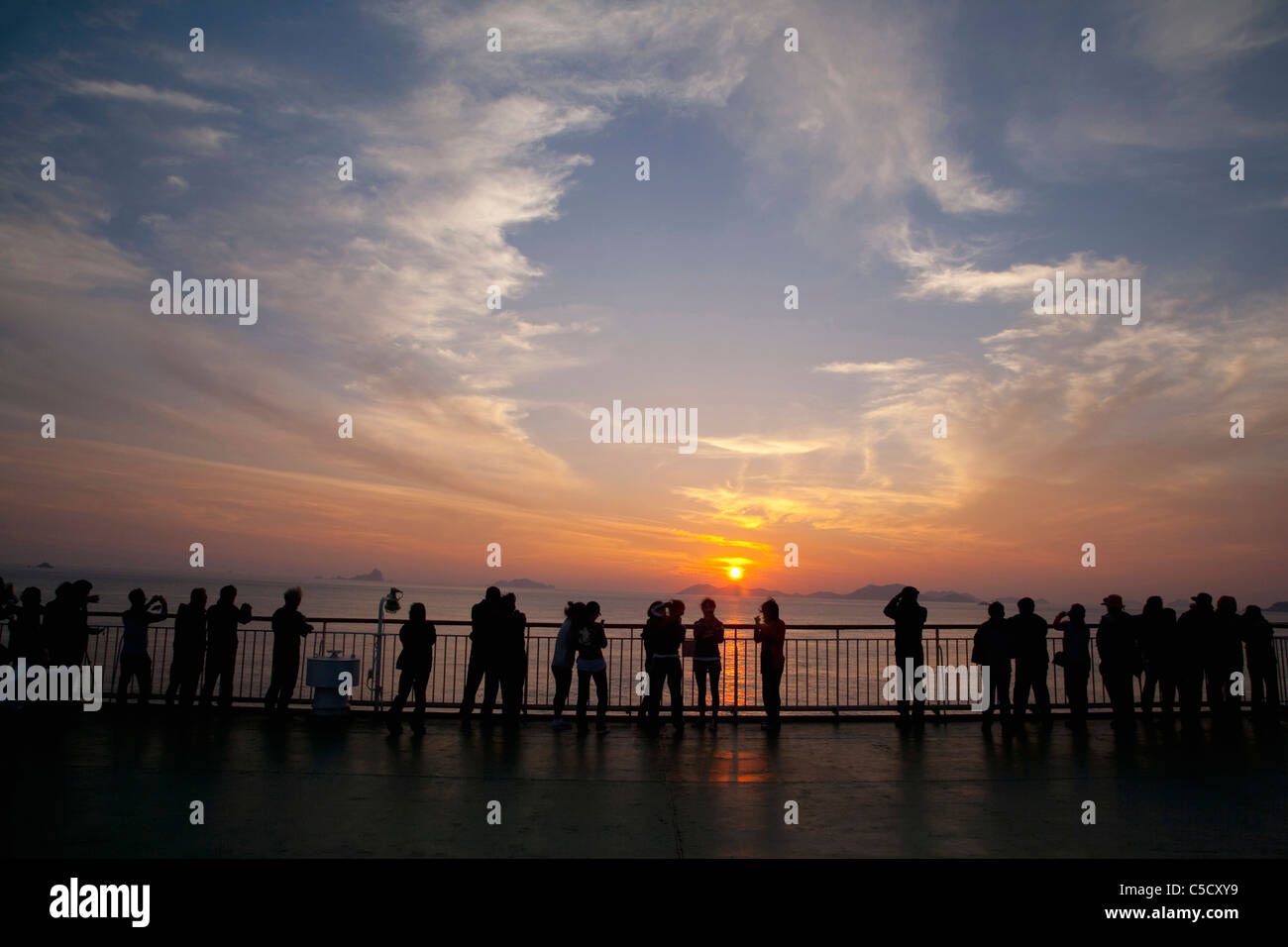 silhouette of the people standing by the beach Stock Photo