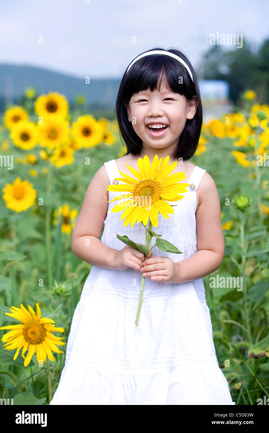 girl holding sunflower in flower field Stock Photo - Alamy