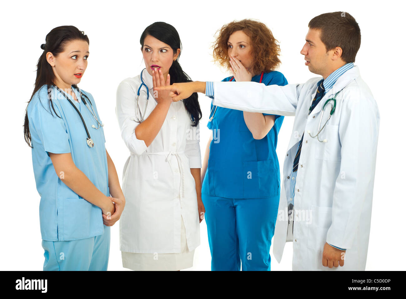 Hospital manager accusing doctor woman and pointing and her colleagues doctors women being surprised and scared isolated Stock Photo