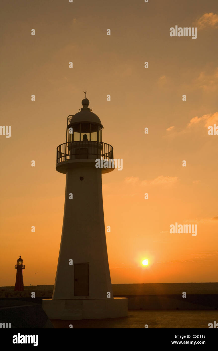 lighthouse under the sunset glow Stock Photo - Alamy