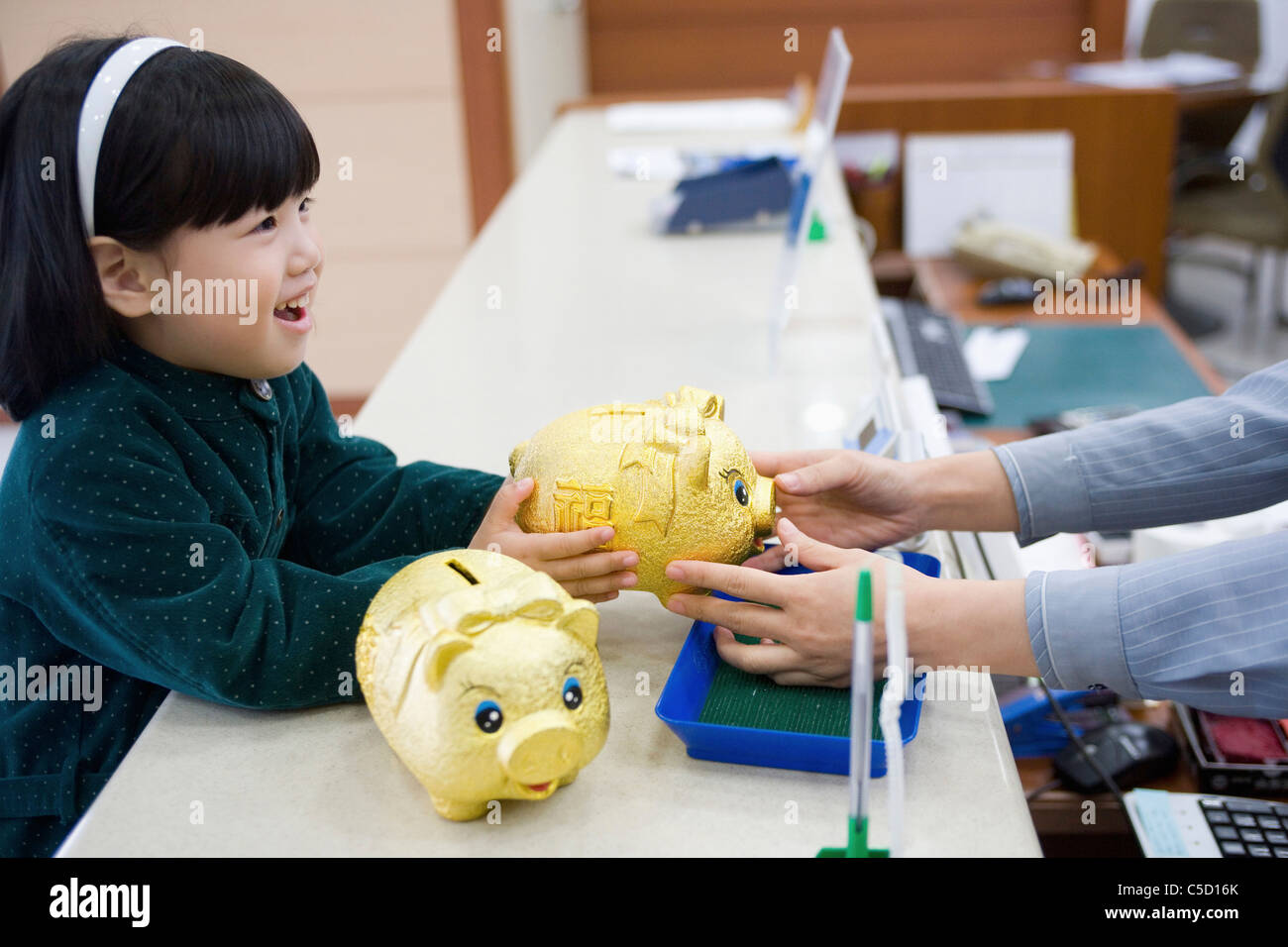 girl took a piggy bank with smile Stock Photo - Alamy