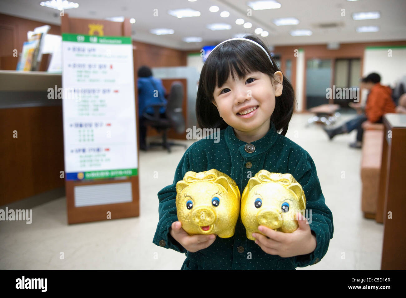 girl holding piggy banks in her arms Stock Photo - Alamy