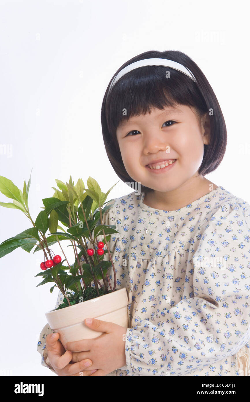girl holding flower pot Stock Photo - Alamy
