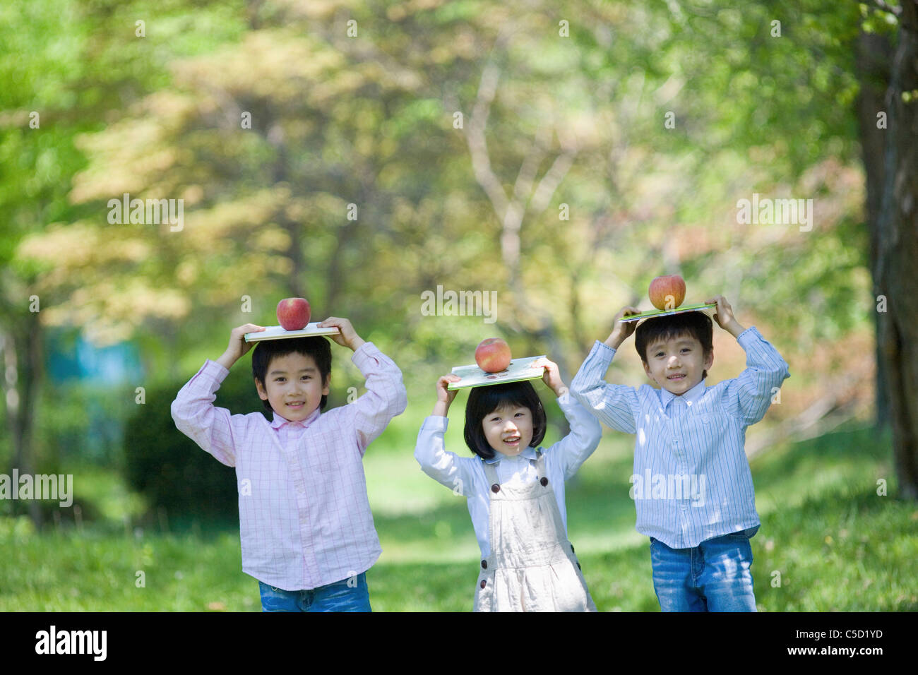 children-balancing-the-book-on-their-head-stock-photo-alamy