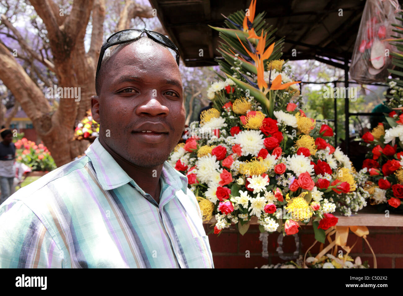 A flower seller at the colourful flower market in Harare, Zimbabwe