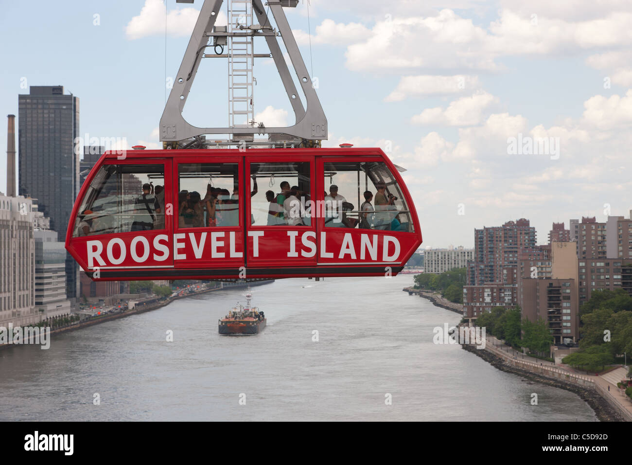 The Roosevelt Island Tram crosses over the East River headed for Manhattan in New York City. Stock Photo