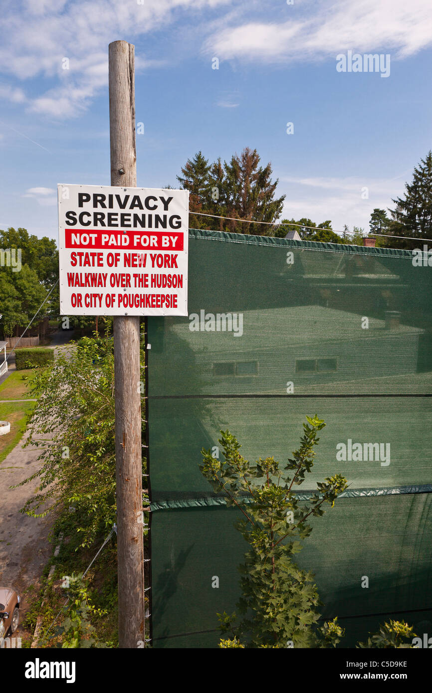 POUGHKEEPSIE, NEW YORK, USA - Privacy screening and sign next to Walkway Over The Hudson State Park. Stock Photo