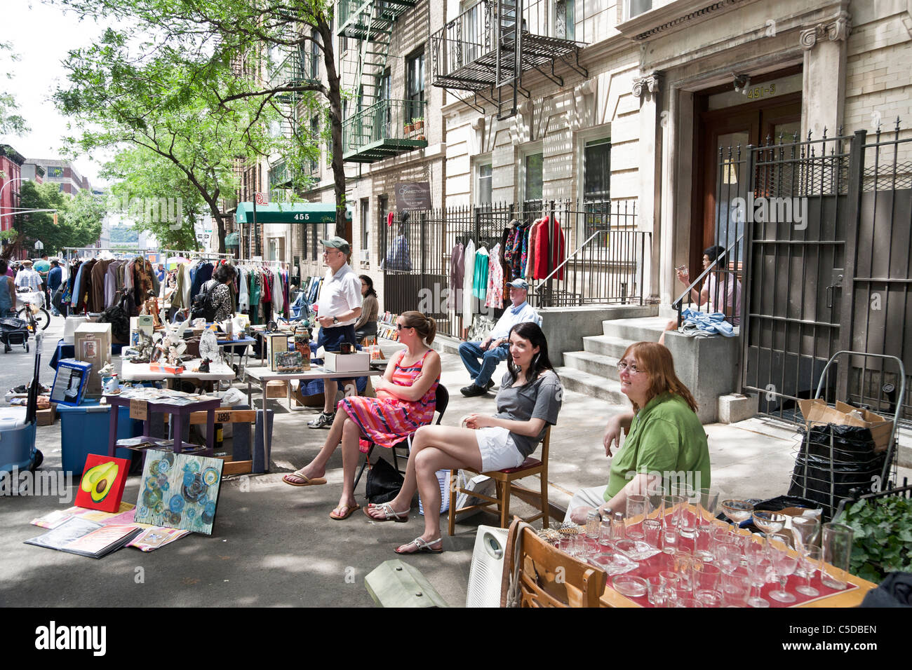 vendors with glassware artwork bric a brac & old clothing liberally displayed along west 44th street at annual flea market sale Stock Photo