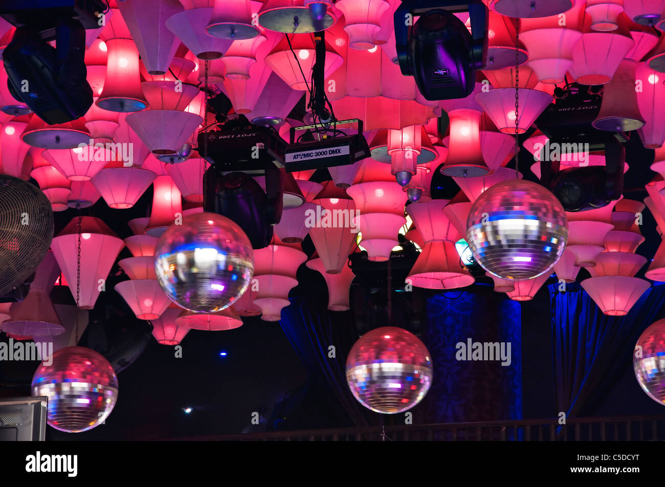 Spinning Disco Balls And Lots Of Pink Lights Hang From The Ceiling
