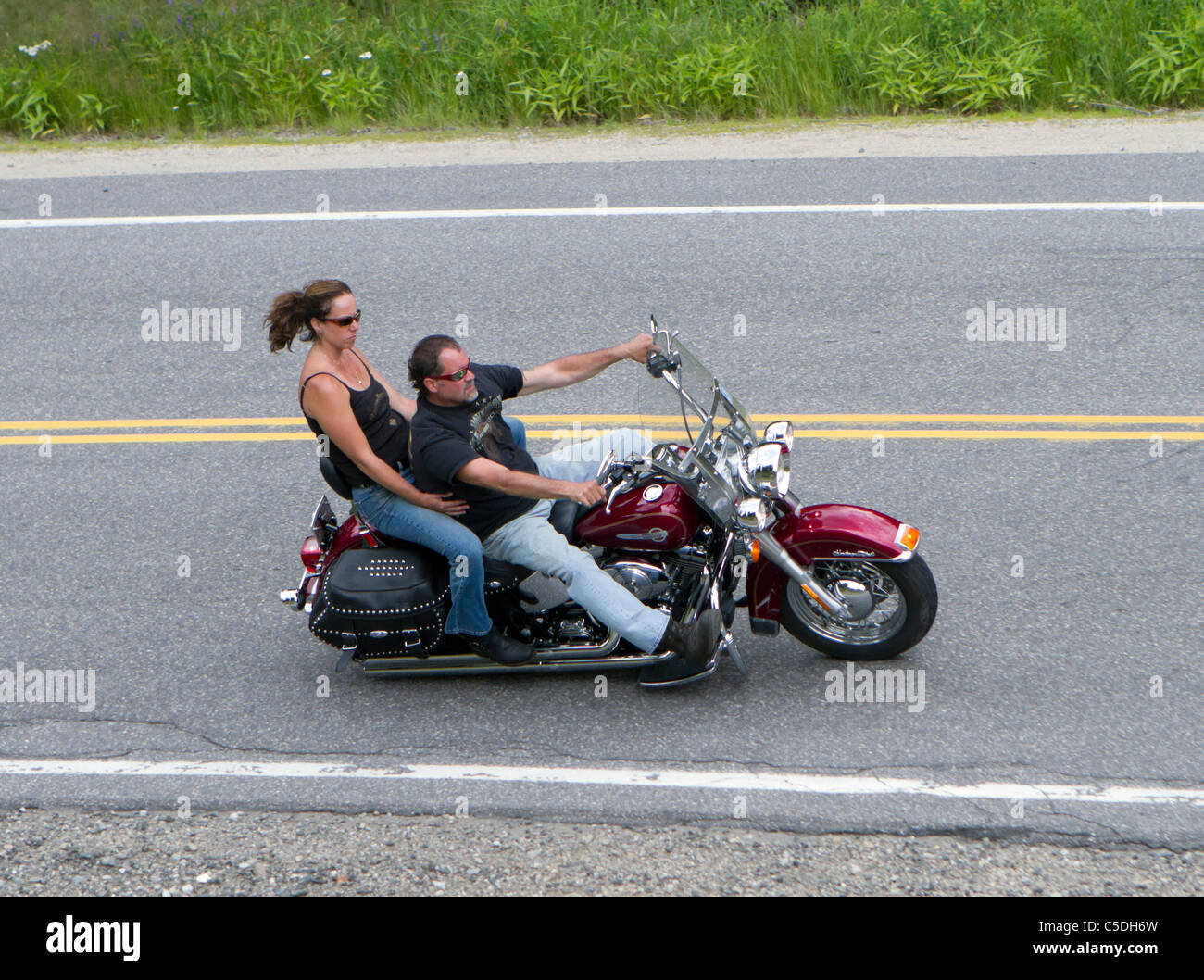 Rider and passenger riding a motorbike motorcycle with no helmets Stock Photo Alamy