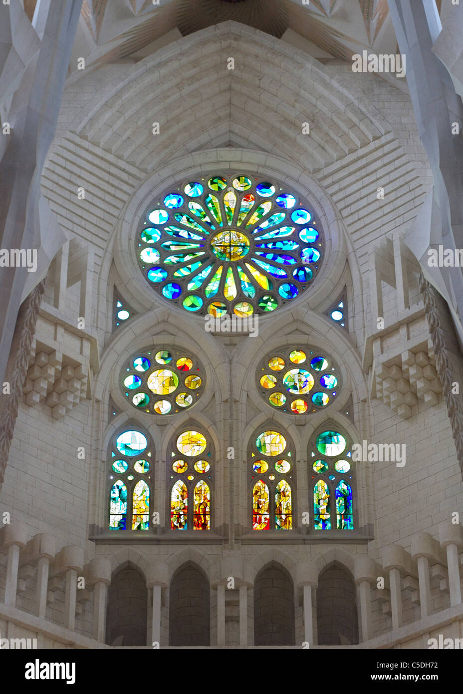 A stain glass window in the interior of Antoni Gaudi's Sagrada Familia Stock Photo