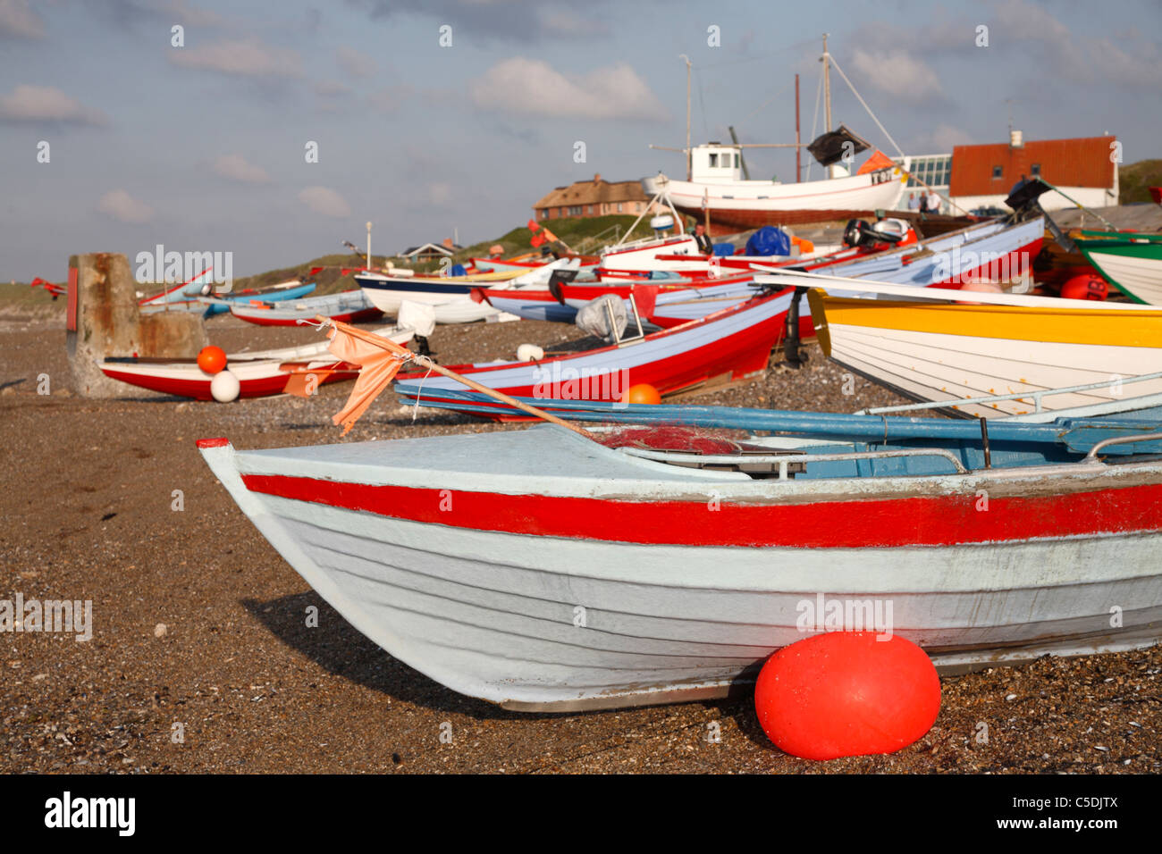 Sundown atmosphere among the drawn up fishing boats at the fishing hamlet Klitmøller on the west coast of Jutland, Denmark Stock Photo