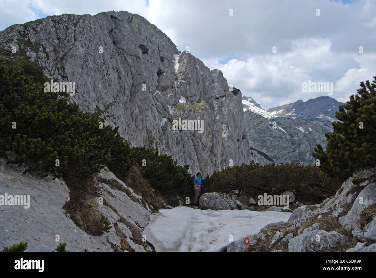 Hiker on pass between Savin kuk (in back) and Meded Peak, Durmitor NP. Montenegro Stock Photo