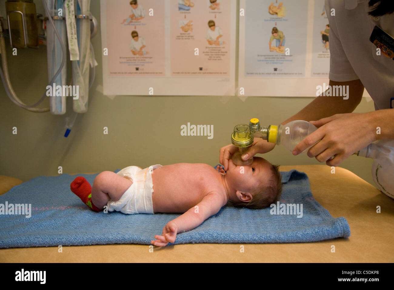 Side view of a baby receiving nebulizer breathing treatment Stock Photo