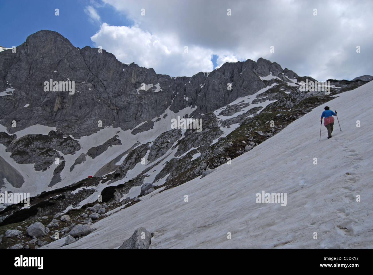 Hiker ascending pass between Savin kuk (in back) and Meded Peak, Durmitor NP. Montenegro Stock Photo