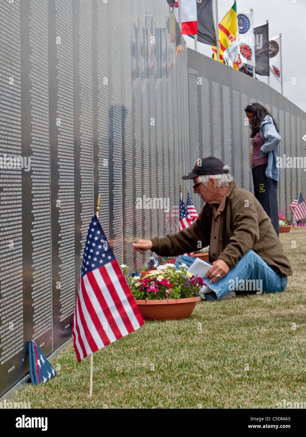 A veteran looks up a name at The Wall That Heals, a traveling half