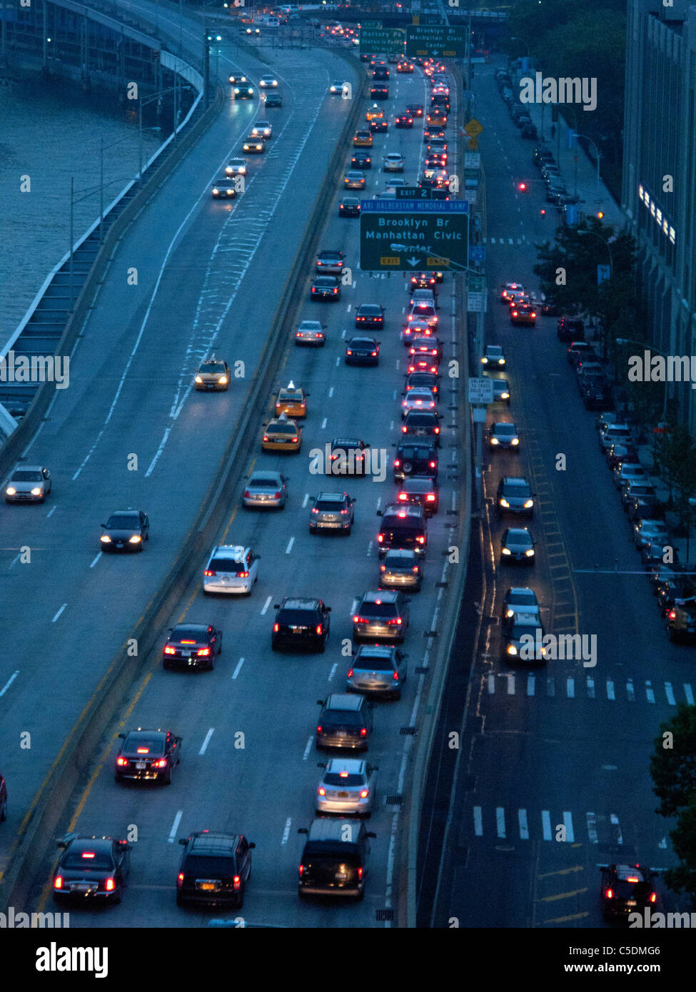 Evening rush hour commuter traffic backs up on New York City's FDR Drive on Manhattan's east side near the Brooklyn Bridge. Stock Photo