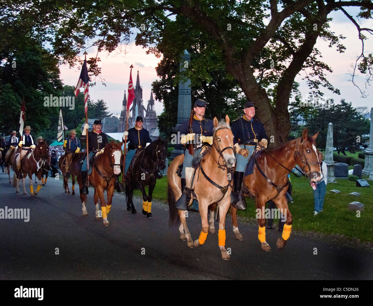 Riding horses, Civil War reenactors wearing period uniform meet on