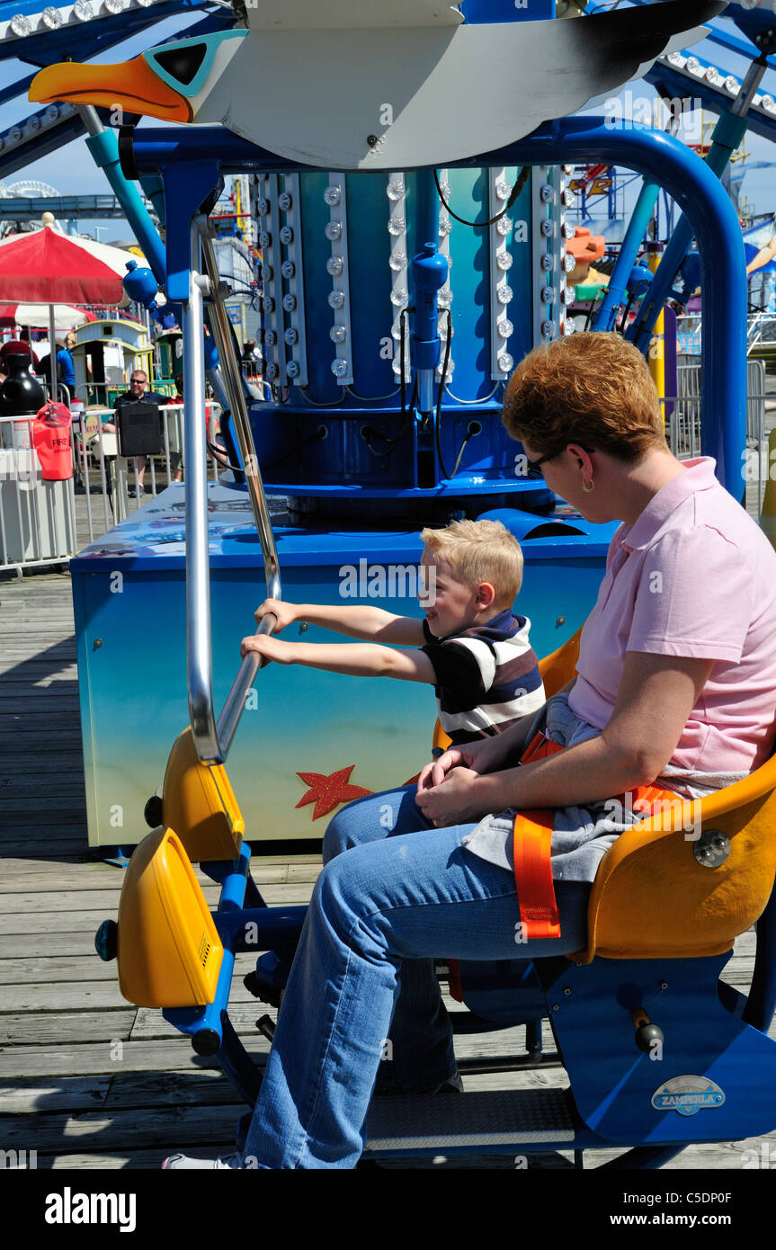 A woman and small boy prepare for an amusement ride in Wildwood, New Jersey Stock Photo
