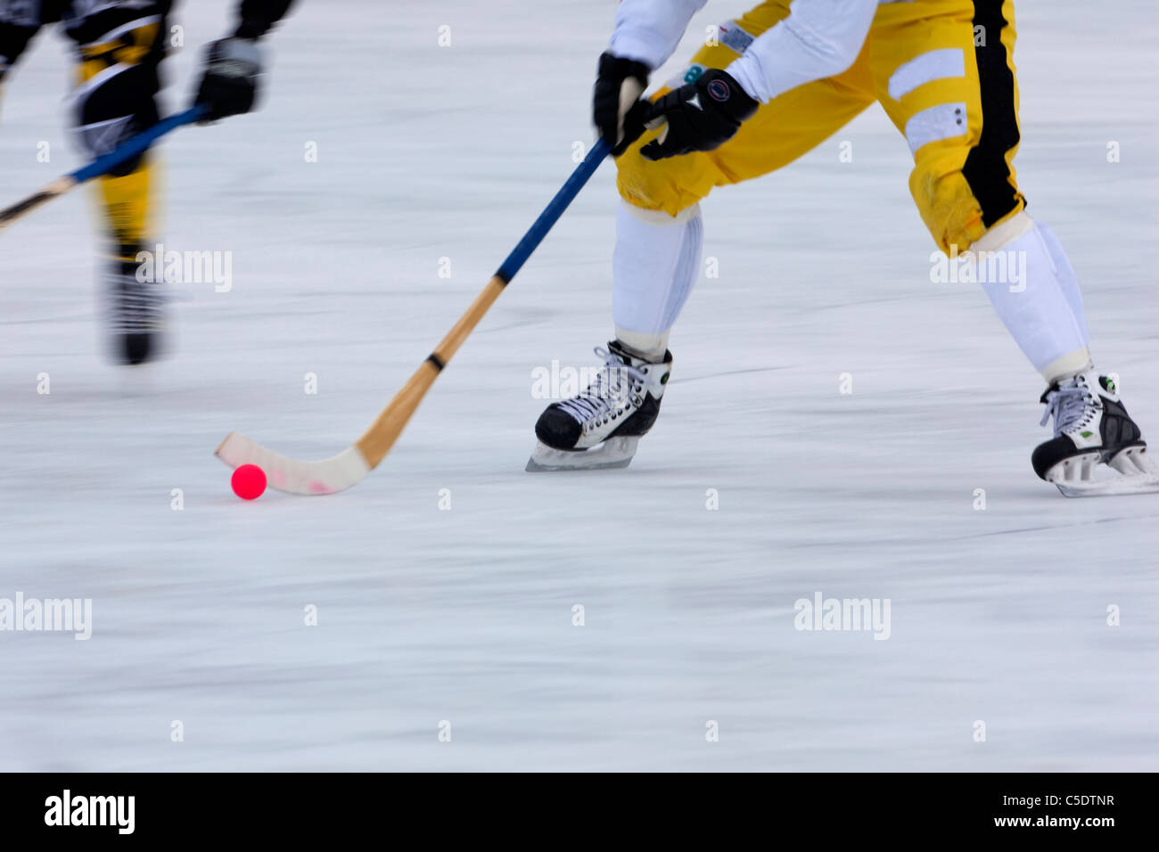 Low section of bandy on ice in blurred motion Stock Photo