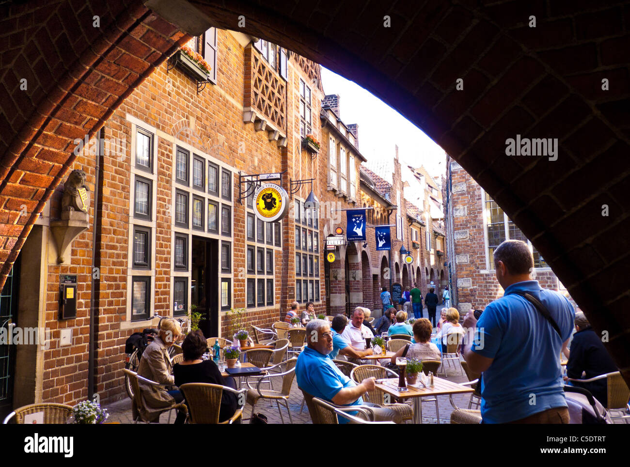 People sitting at a restaurant in the Böttcherstraße - Bremen, Germany Stock Photo
