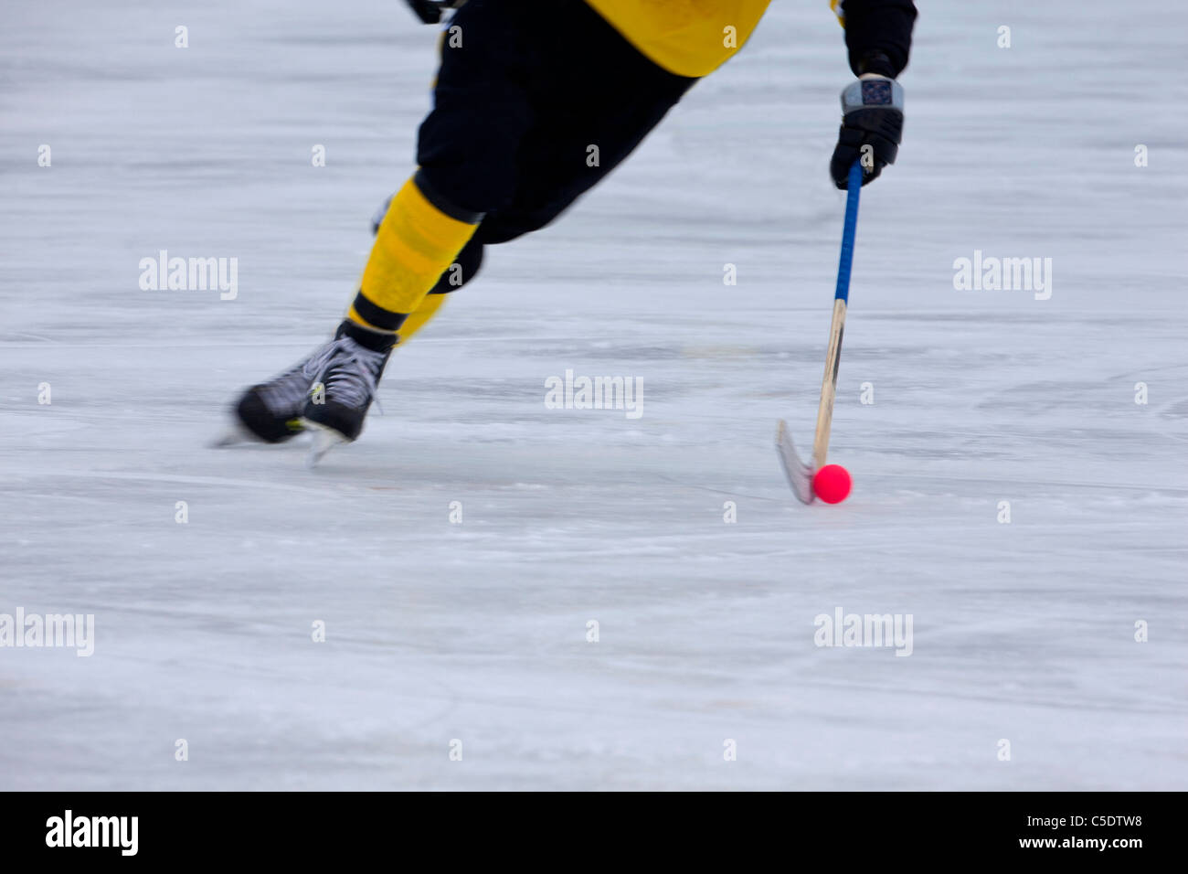 Low section of bandy on in blurred motion Stock Photo