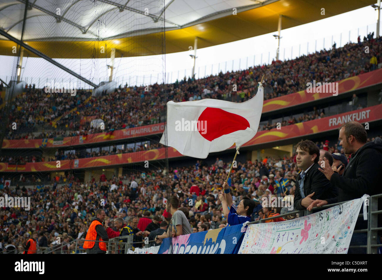 Fans waving Japanese flag for FIFA Women's World Cup Germany 2011 Semi-final match between Japan 3-1 Sweden. Stock Photo