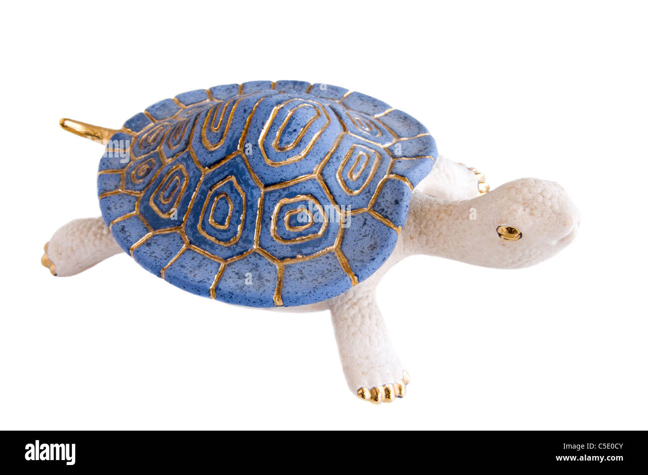 Blue and white painted clay turtle figurine against white background Stock Photo