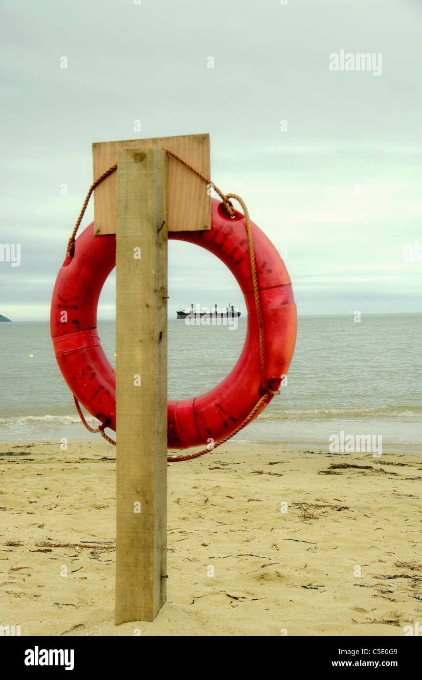 lifebuoy on the beach before the storm against the ship Stock Photo