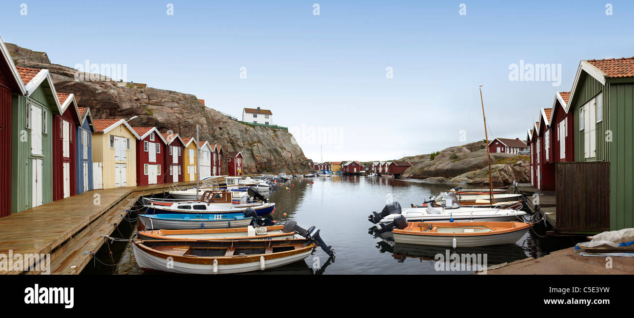 Panoramic shot of moored boats along houses against clear sky Stock Photo