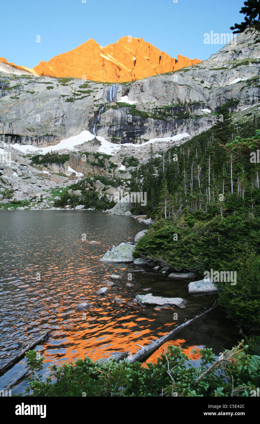 Black Lake in rocky Mountain National Park with early light on the peaks behind it Stock Photo