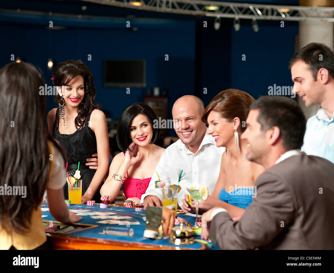group of people playing blackjack or poker, smiling Stock Photo