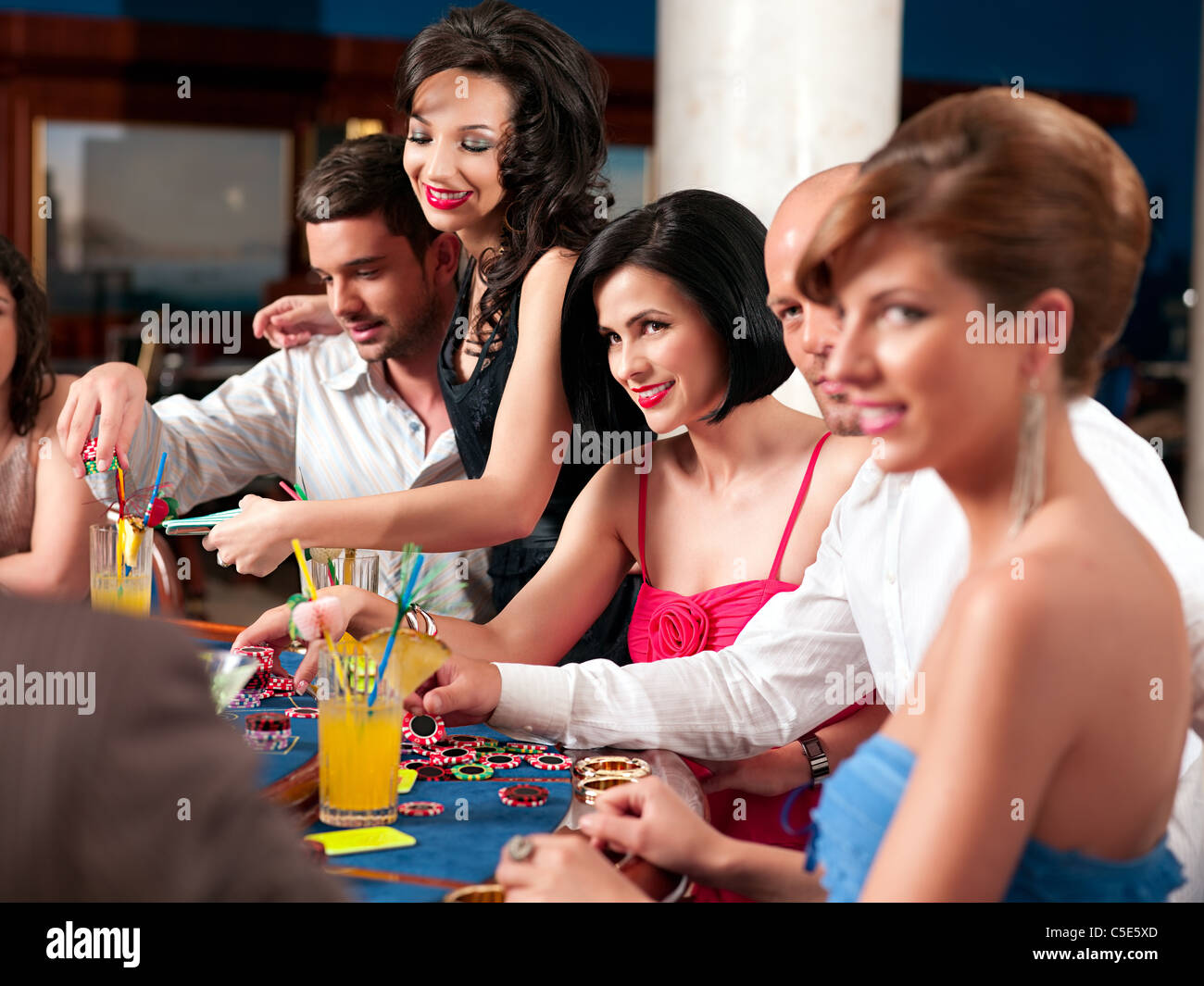group of people playing blackjack or poker, smiling Stock Photo