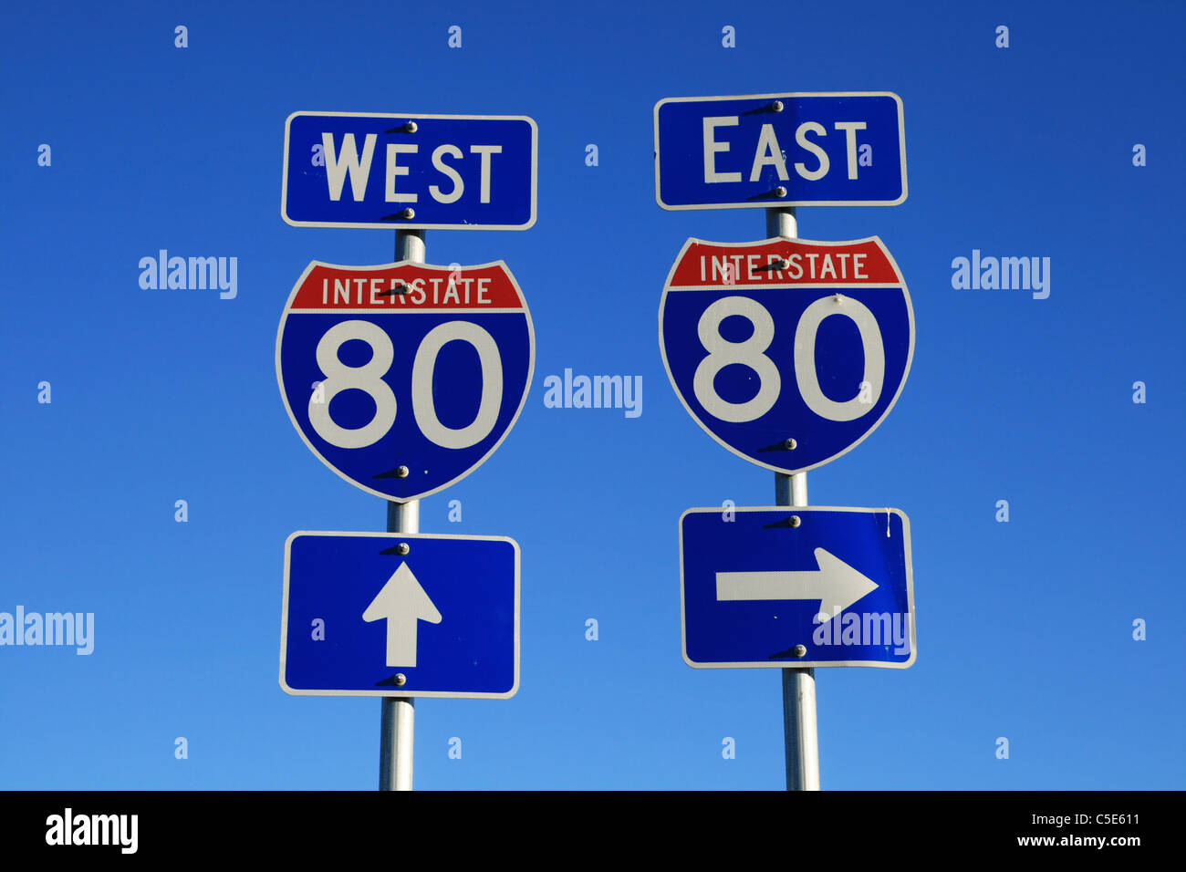 road signs for interstate 80 east and west with blue sky background Stock Photo