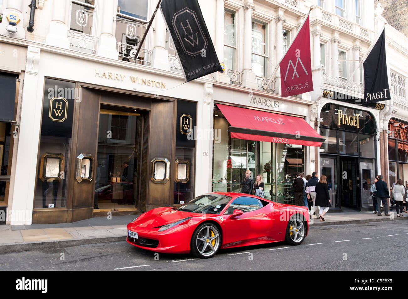 Red Ferrari car parked on New Bond Street, London, UK Stock Photo