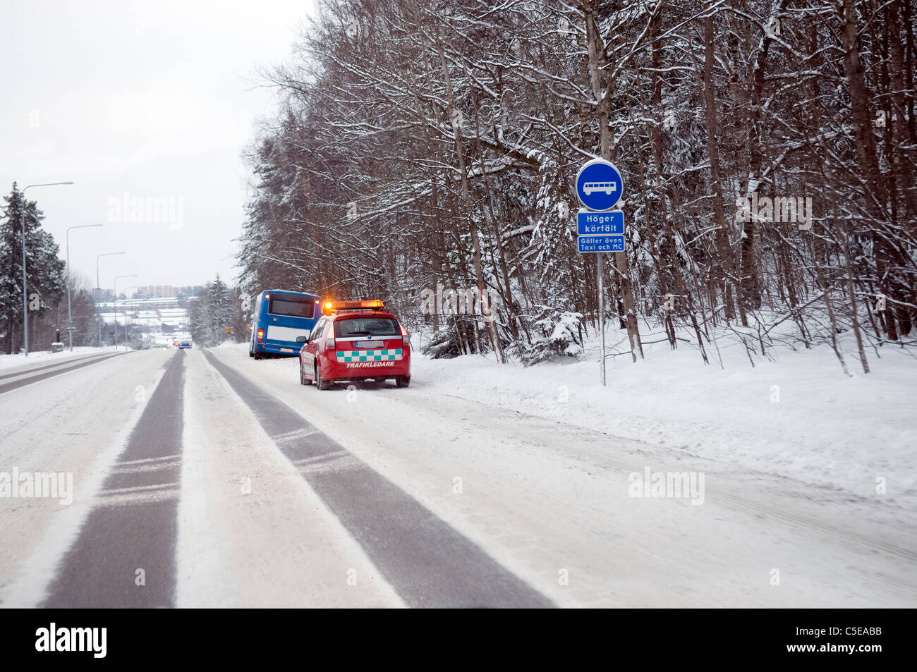 Rear mid distance shot of a rescue car at a road accident in winter Stock Photo