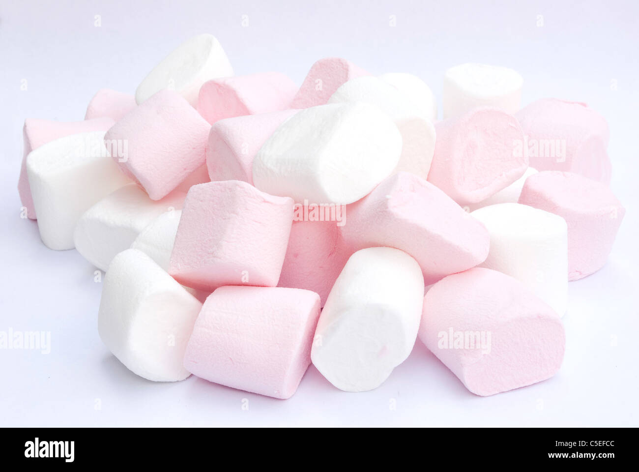 white and pink fluffy candies on gray background Stock Photo Alamy