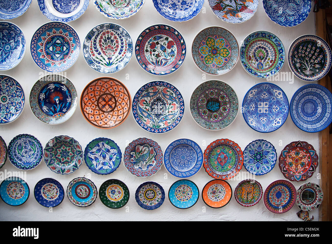 Colourful bowls hanging from a wall Stock Photo Alamy