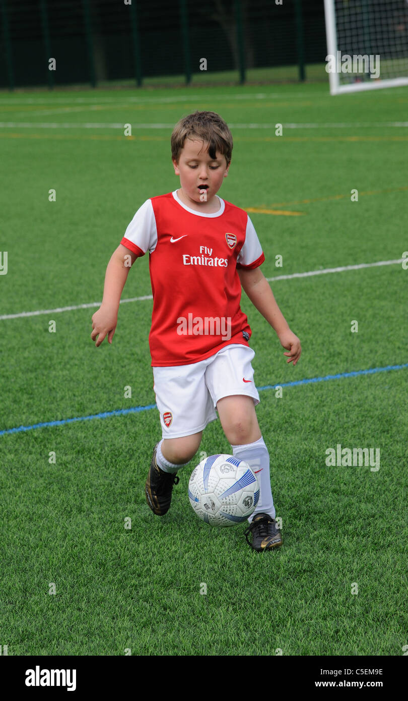 https://c8.alamy.com/comp/C5EM9E/young-footballer-in-control-of-the-ball-on-a-astra-turf-pitch-C5EM9E.jpg