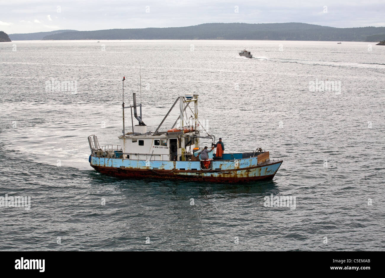 Commercial crab fisherman gathering crab pots in Puget Sound near the