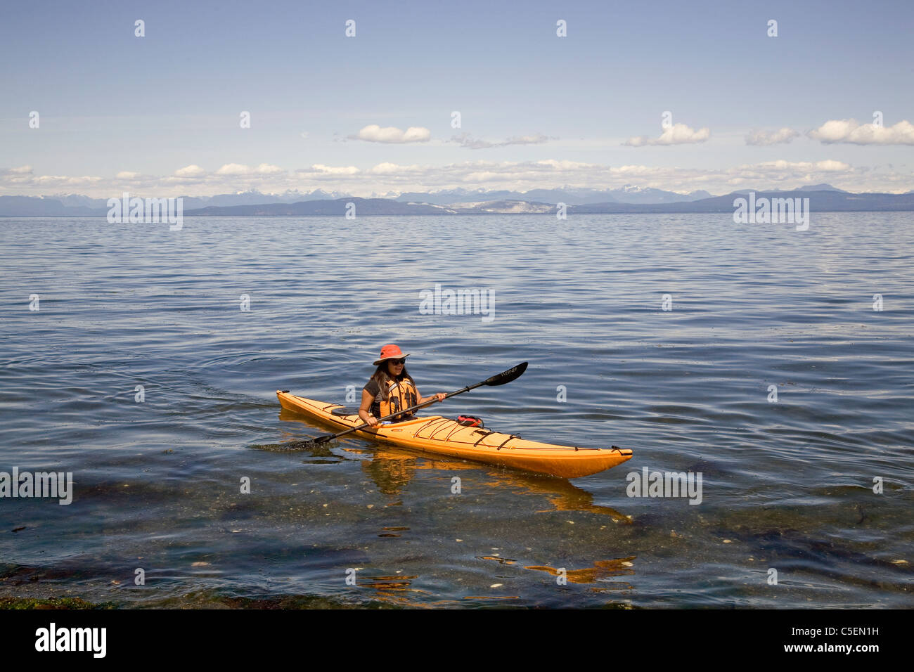 A girl in a sea kayak on Hornby Island, Strait of British Columbia, Canada Stock Photo