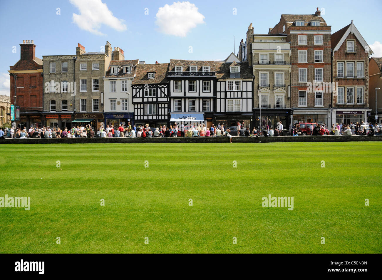Cambridge historic town center buildings on Kings Parade with college lawn grass freshly cut Stock Photo